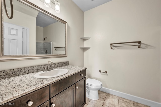 bathroom with a shower with door, vanity, tile patterned floors, and toilet