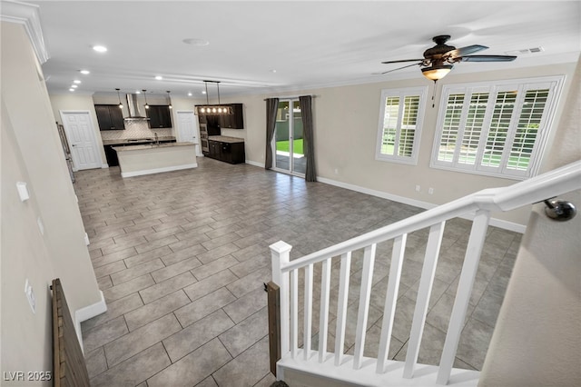 interior space with crown molding and ceiling fan