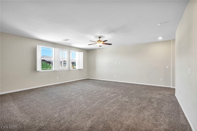 spare room with ceiling fan and carpet