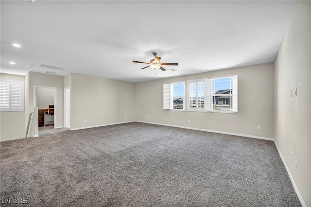 carpeted spare room with ceiling fan