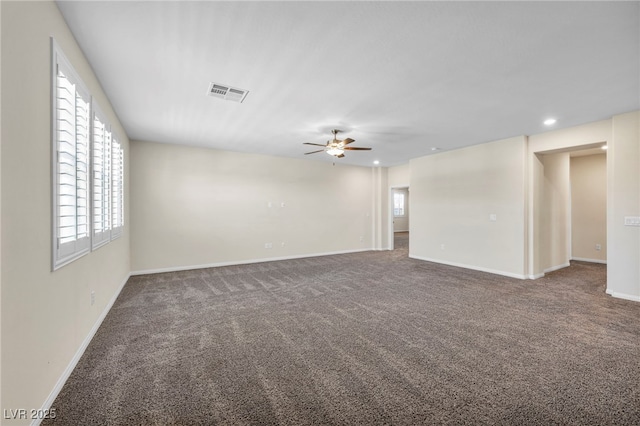 unfurnished room with ceiling fan and carpet