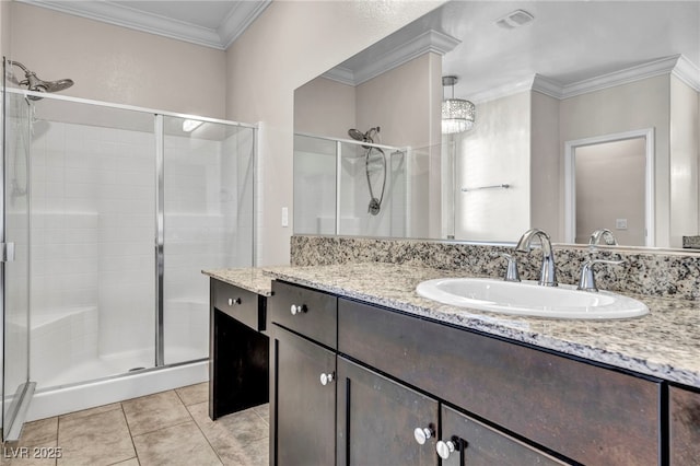 bathroom featuring tile patterned flooring, vanity, ornamental molding, and walk in shower