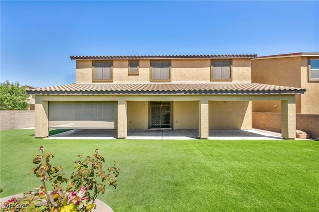 back of property with a patio and a lawn