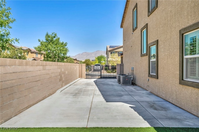 view of side of property featuring a mountain view and a patio area