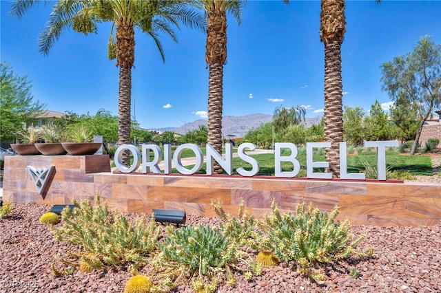 community / neighborhood sign with a mountain view