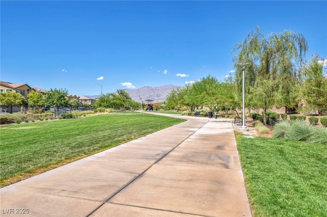 surrounding community featuring a yard and a mountain view