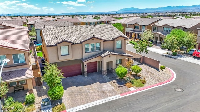 view of front of home featuring a garage and a mountain view