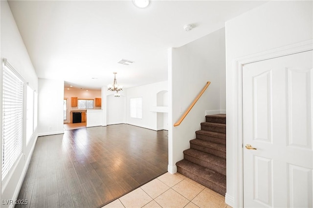 interior space with an inviting chandelier and light hardwood / wood-style floors