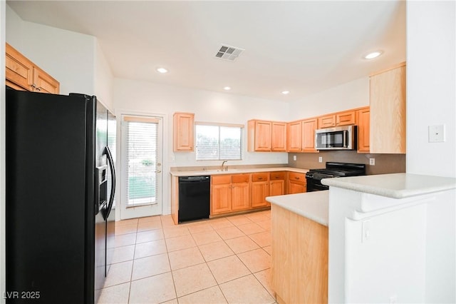 kitchen featuring light tile patterned flooring, black appliances, sink, kitchen peninsula, and light brown cabinets