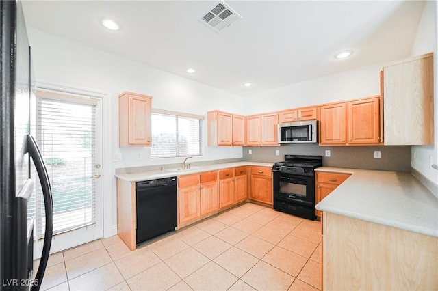 kitchen featuring light tile patterned flooring, sink, light brown cabinets, and black appliances