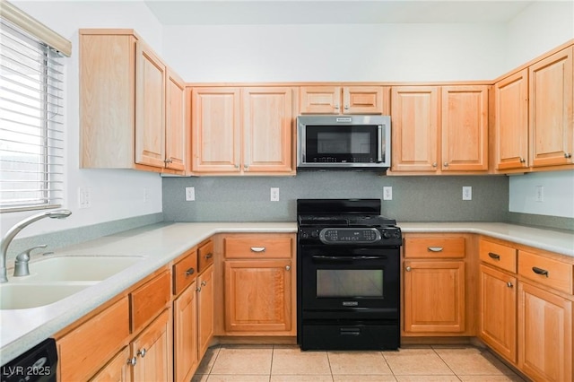 kitchen featuring sink, light tile patterned floors, and black appliances