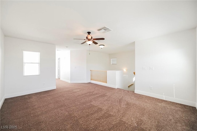 unfurnished room featuring ceiling fan and carpet flooring