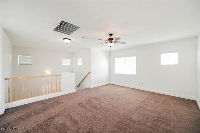 unfurnished room with ceiling fan and carpet floors