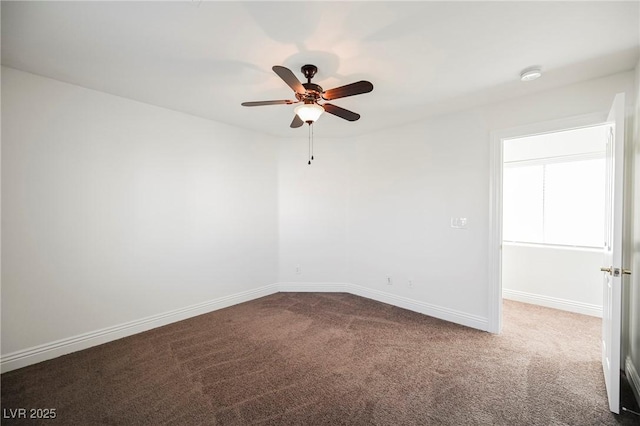 spare room featuring ceiling fan and carpet