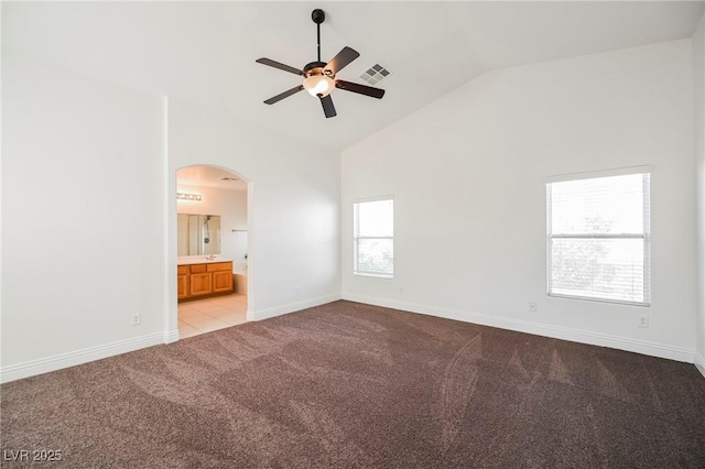 spare room featuring light carpet, high vaulted ceiling, and ceiling fan