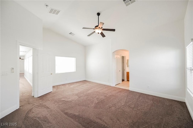 carpeted empty room featuring high vaulted ceiling and ceiling fan