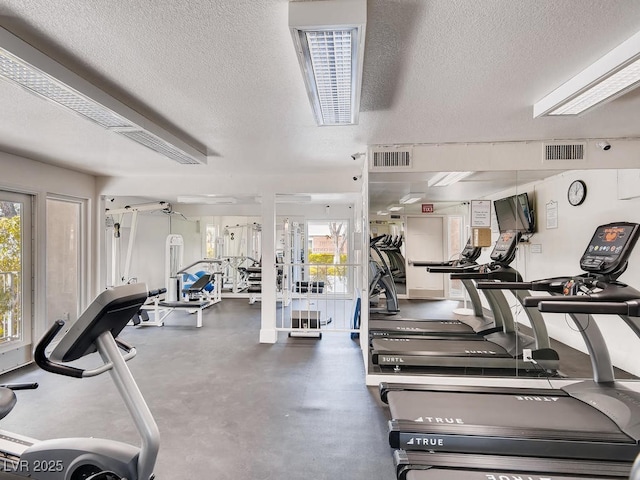 workout area with a textured ceiling