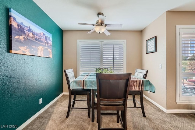 dining area with carpet floors and ceiling fan