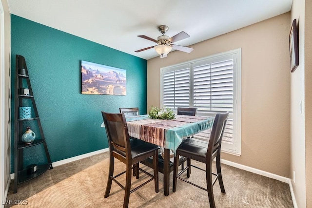 dining area featuring carpet floors and ceiling fan