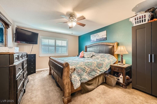 bedroom featuring light carpet and ceiling fan