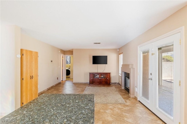 unfurnished living room with washer / dryer