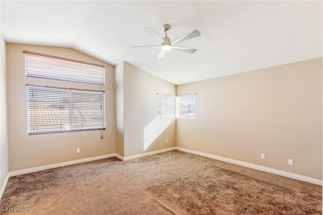 empty room with ceiling fan, lofted ceiling, and carpet