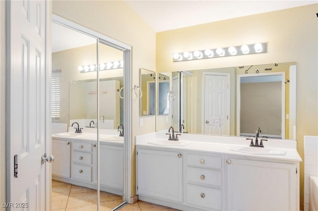 bathroom with vanity, tile patterned floors, and a bathtub