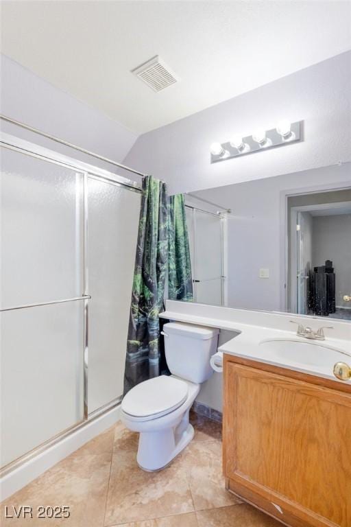 bathroom with vaulted ceiling, vanity, a shower with shower door, tile patterned floors, and toilet