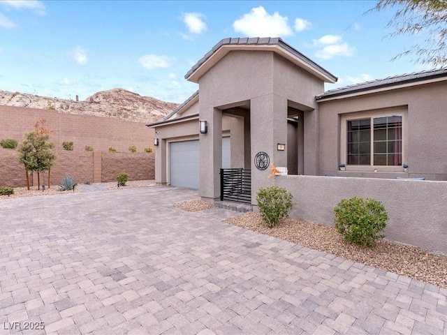 view of front of house featuring a garage and a mountain view