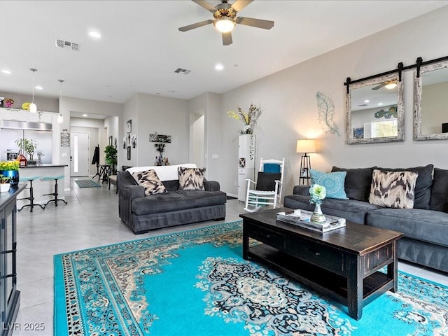 tiled living room featuring ceiling fan