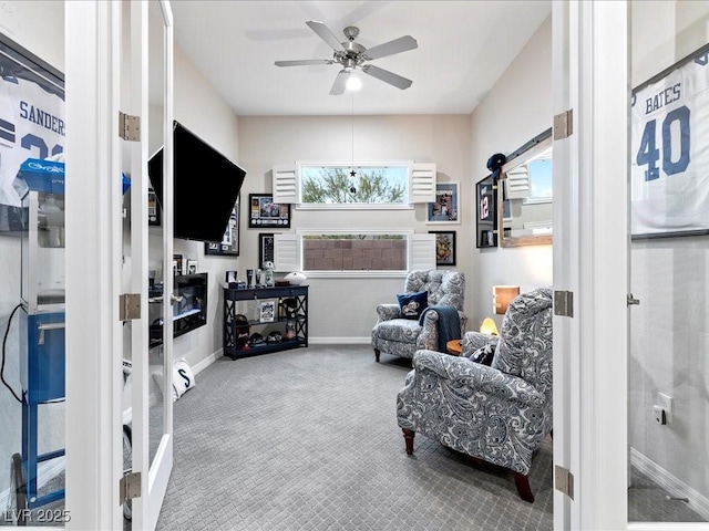 sitting room featuring ceiling fan, plenty of natural light, and carpet flooring