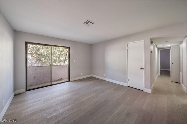 spare room with light hardwood / wood-style floors