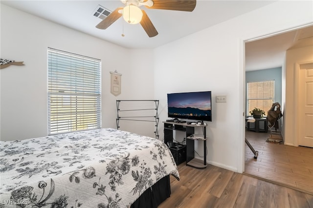 bedroom with ceiling fan and wood-type flooring