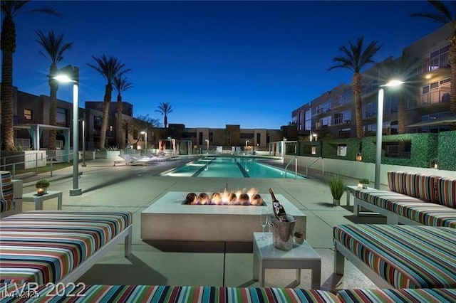 view of pool featuring a patio area and a fire pit