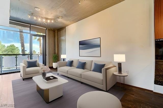 living room with floor to ceiling windows and dark hardwood / wood-style floors