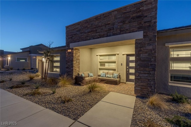 entrance to property featuring an outdoor living space