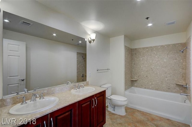 full bathroom with vanity, toilet, and tiled shower / bath combo