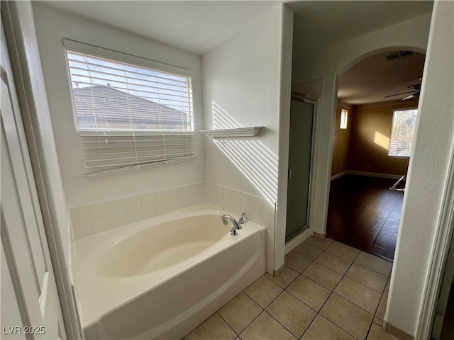 bathroom with tile patterned flooring, ceiling fan, and separate shower and tub