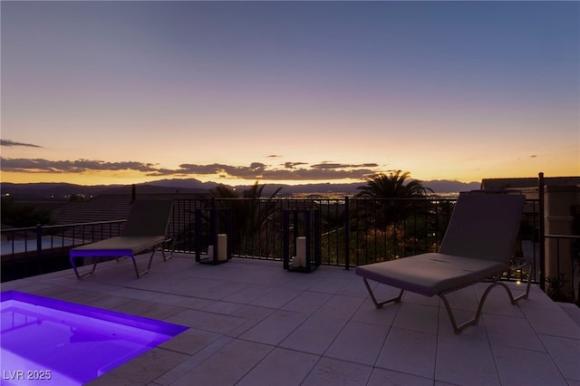 view of patio terrace at dusk