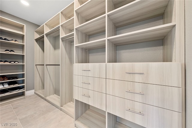 spacious closet featuring light tile patterned floors