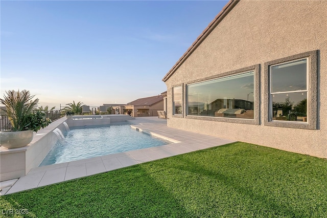 view of pool featuring pool water feature, a yard, and a patio area