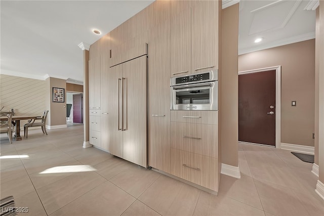 kitchen with light tile patterned flooring, stainless steel oven, crown molding, paneled fridge, and light brown cabinets