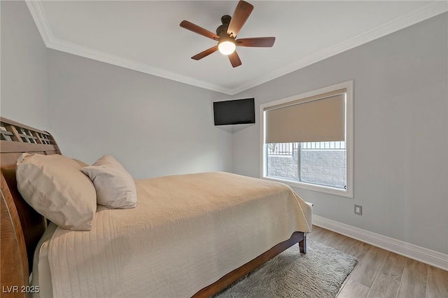 bedroom featuring ornamental molding, ceiling fan, and light hardwood / wood-style flooring