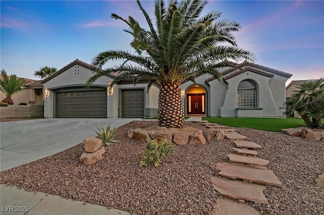 mediterranean / spanish-style home featuring a garage