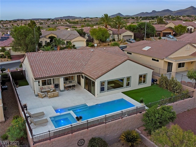 view of pool featuring a mountain view, a yard, a patio area, and outdoor lounge area