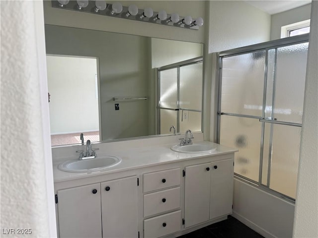 bathroom featuring vanity and shower / bath combination with glass door