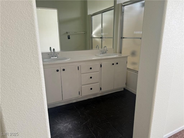 bathroom featuring vanity and shower / bath combination with glass door