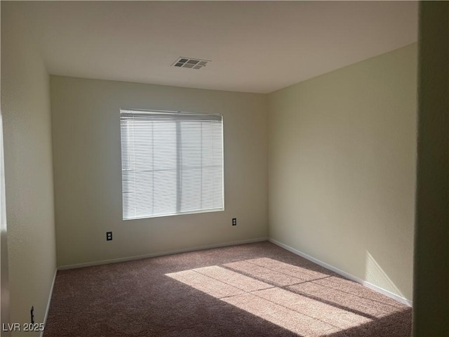 spare room featuring light colored carpet