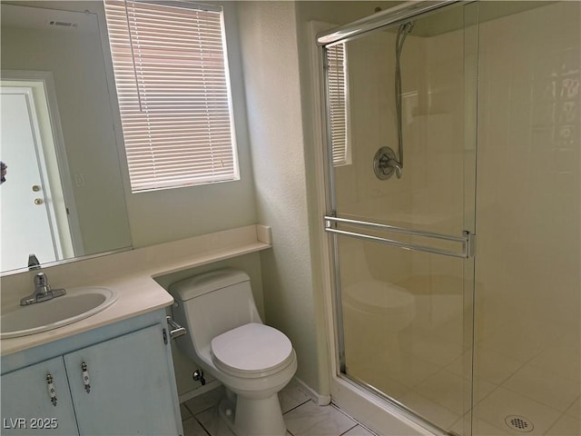 bathroom featuring vanity, toilet, and a shower with door