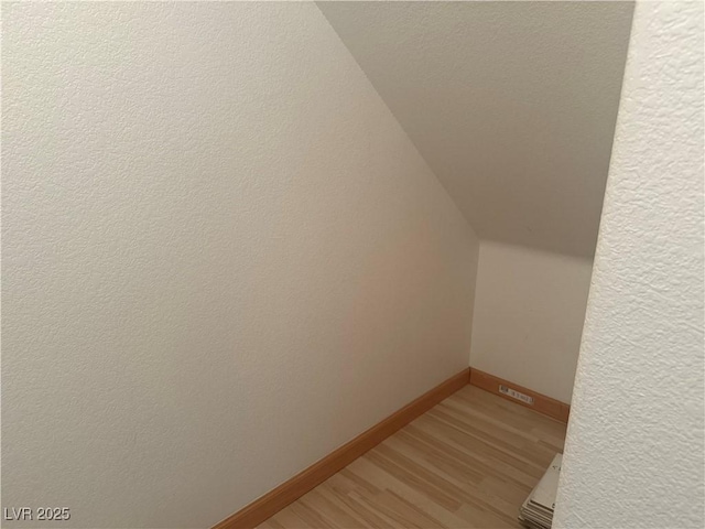 interior space featuring lofted ceiling and light wood-type flooring